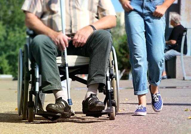 A resident in a wheelchair with a carer