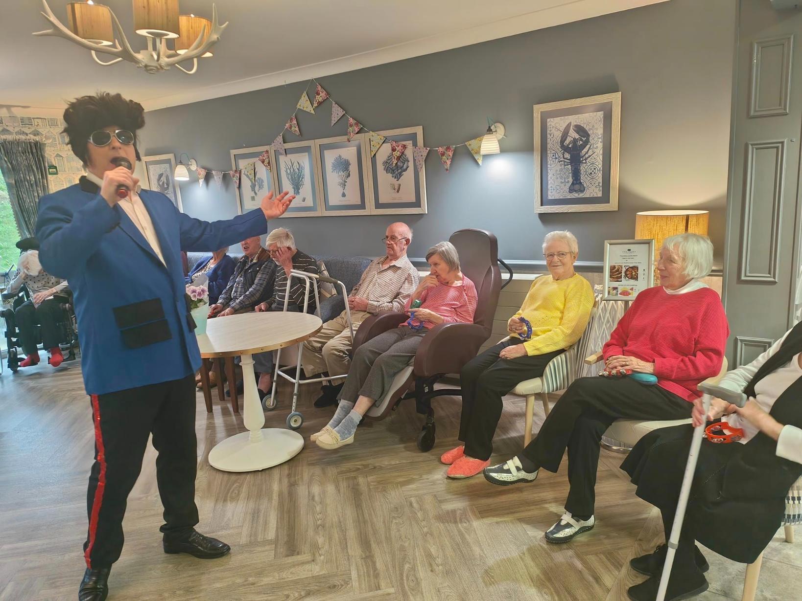 entertainer singing to residents in the cove bistro