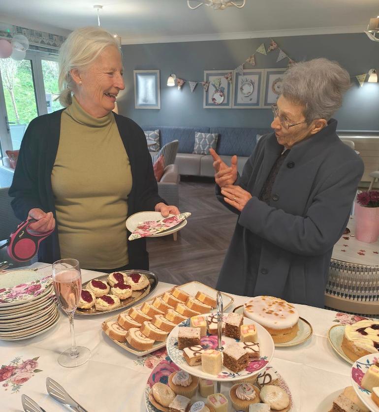 residents chatting with cake