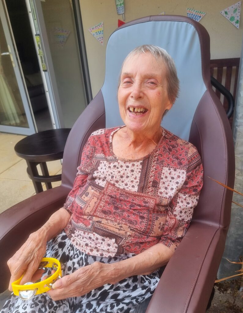 Care Home Residents Enjoying Entertainment in the sun