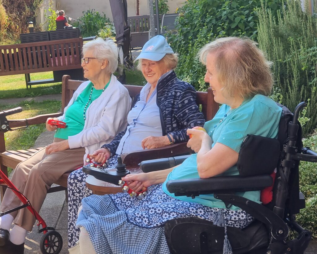 Care Home Residents Enjoying Entertainment in the sun