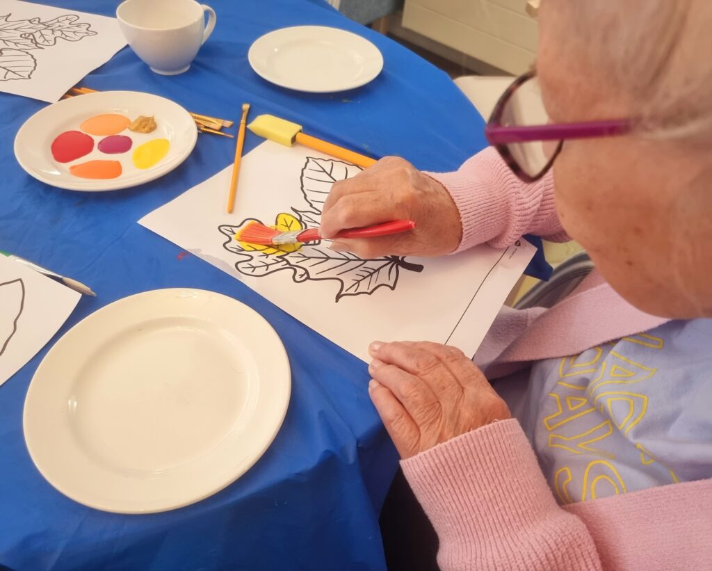 Care Home Residents Painting in the Cafe Area