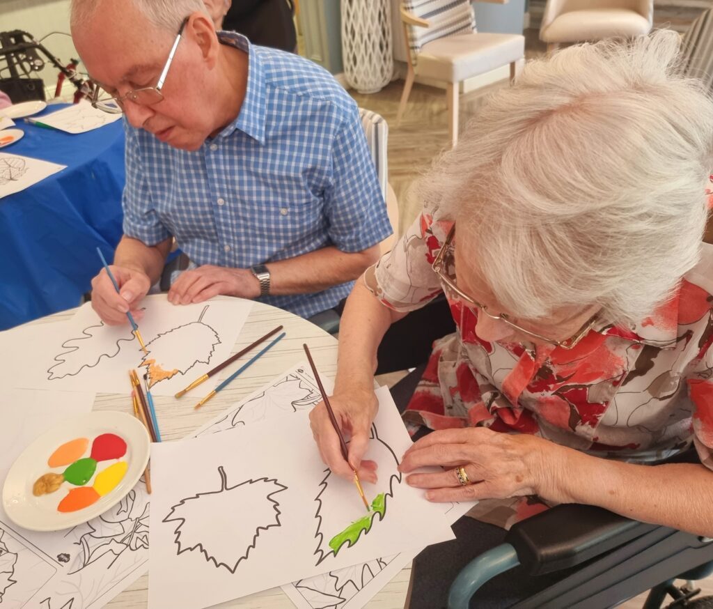 Care Home Residents Painting in the Cafe Area