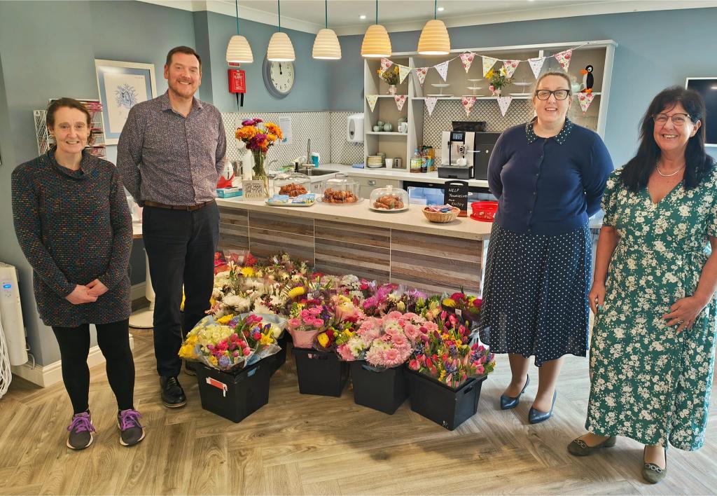 staff with flowers donation