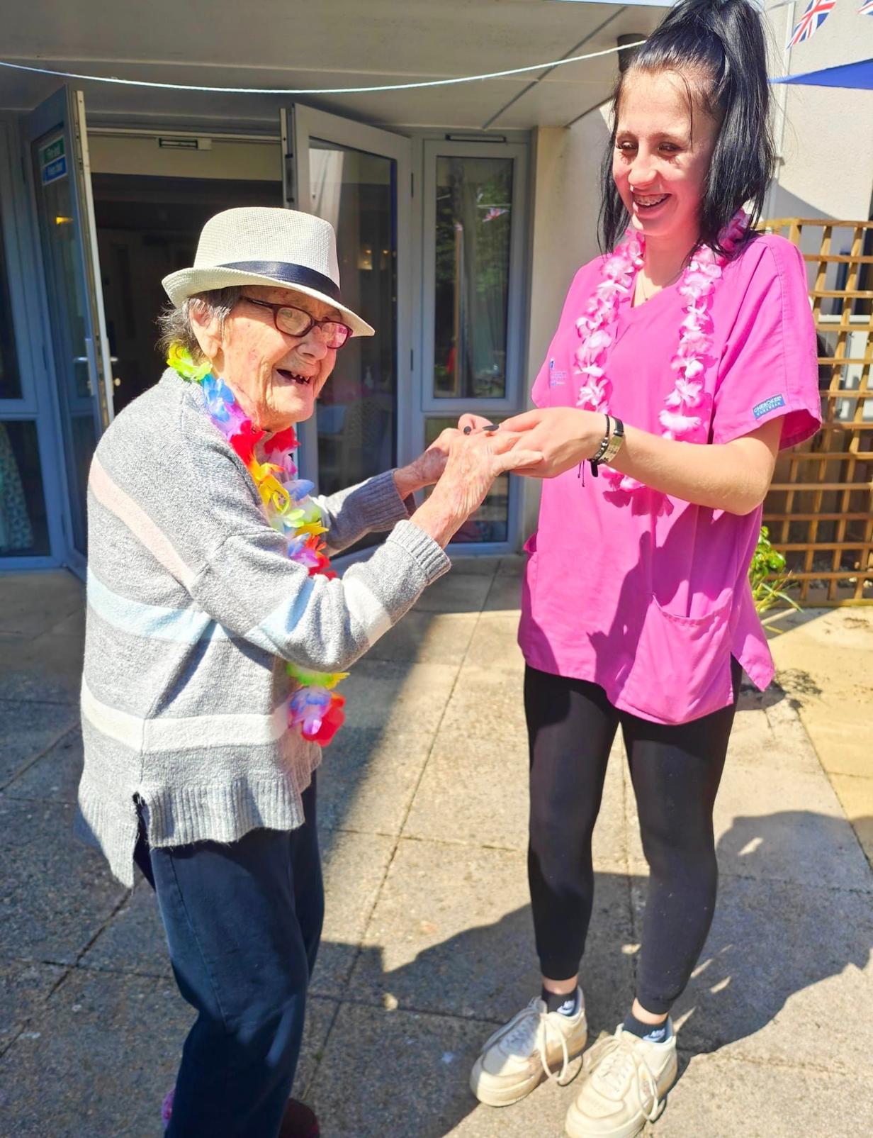 resident dancing with staff member