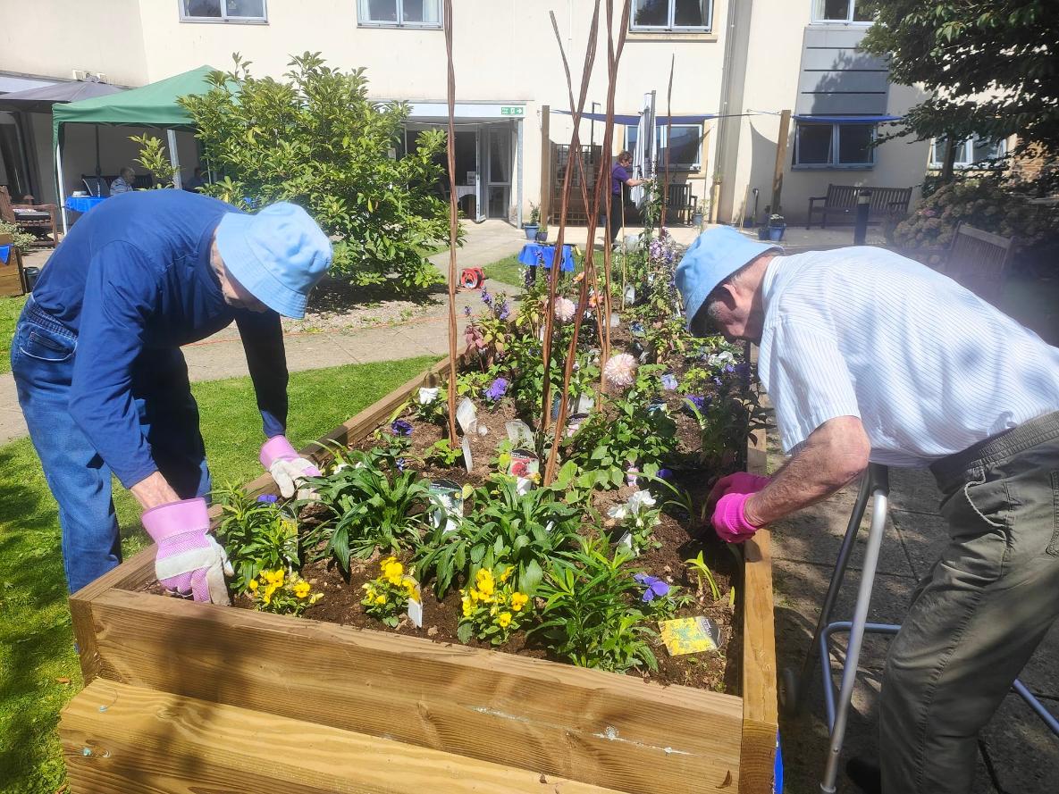 some of our residents planting flowers together