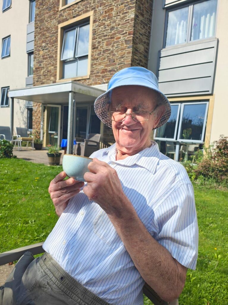 resident enjoying a cup of tea in the garden