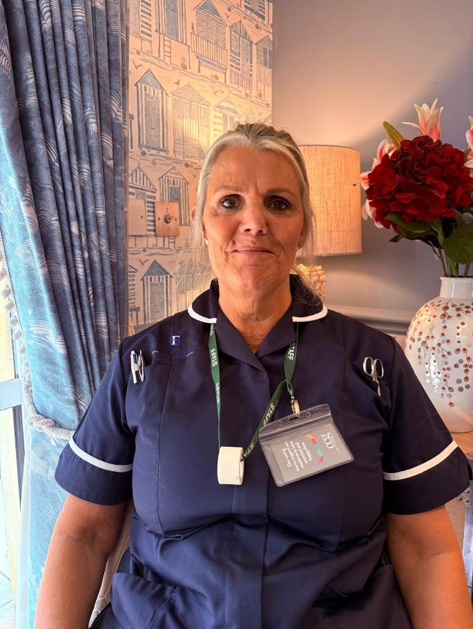 lady smiling at the camera posing for a staff photo