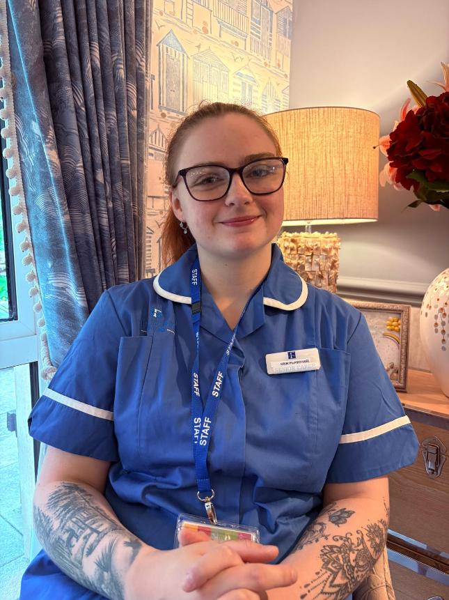 lady smiling at the camera posing for a staff photo