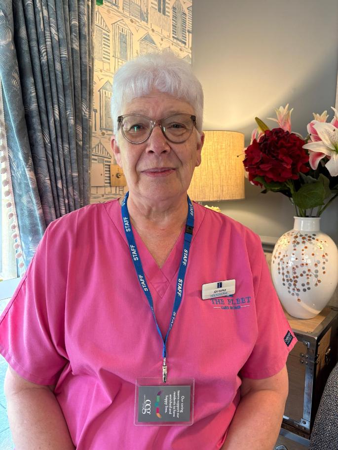 lady smiling at the camera posing for a staff photo