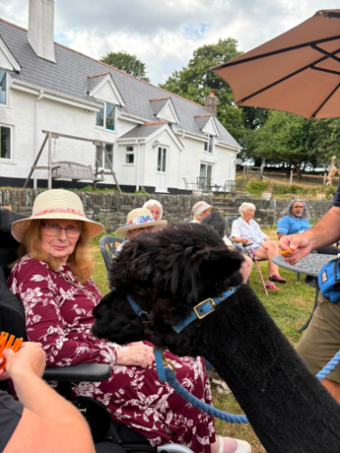 Group of residents and staff on an outing to Lakemoor Alpacas Farm